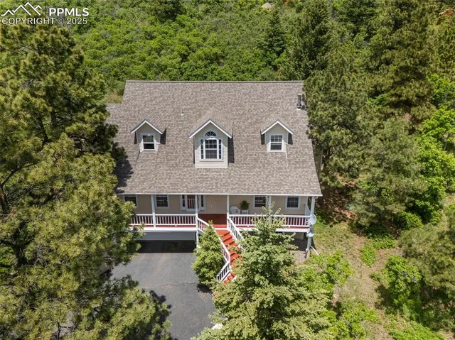 a aerial view of a house with a yard and potted plants