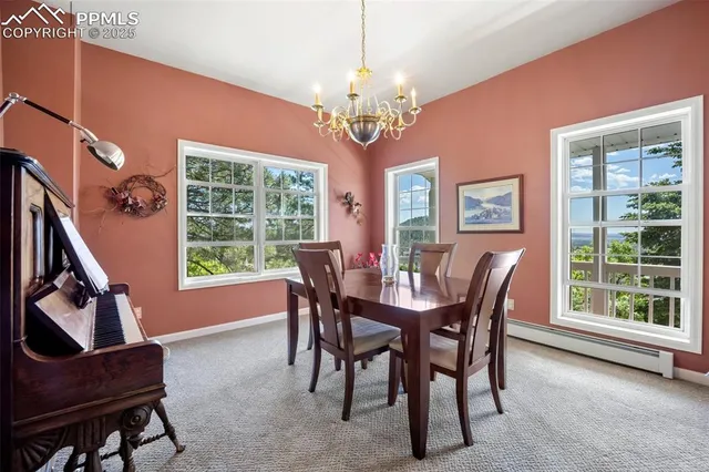 a dining room with furniture and chandelier