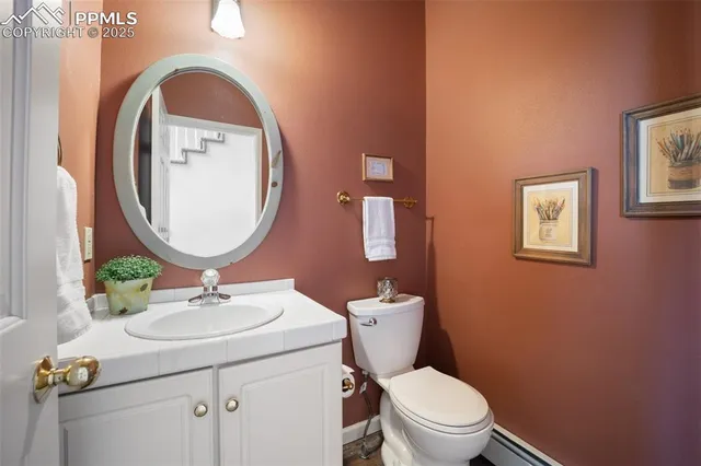 a bathroom with a sink mirror and toilet