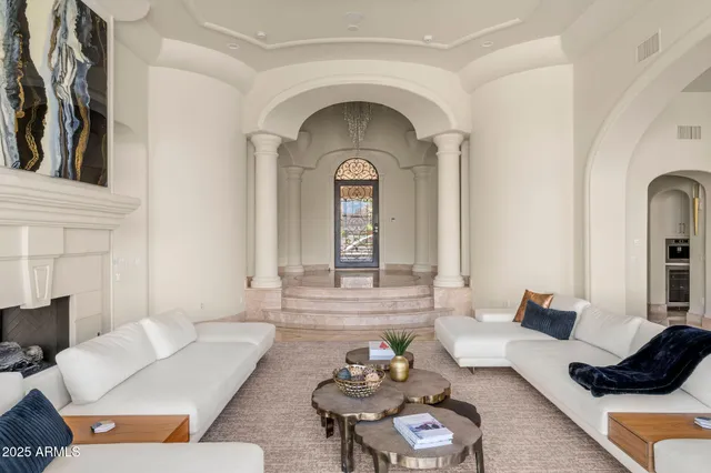 a living room with furniture and a potted plant