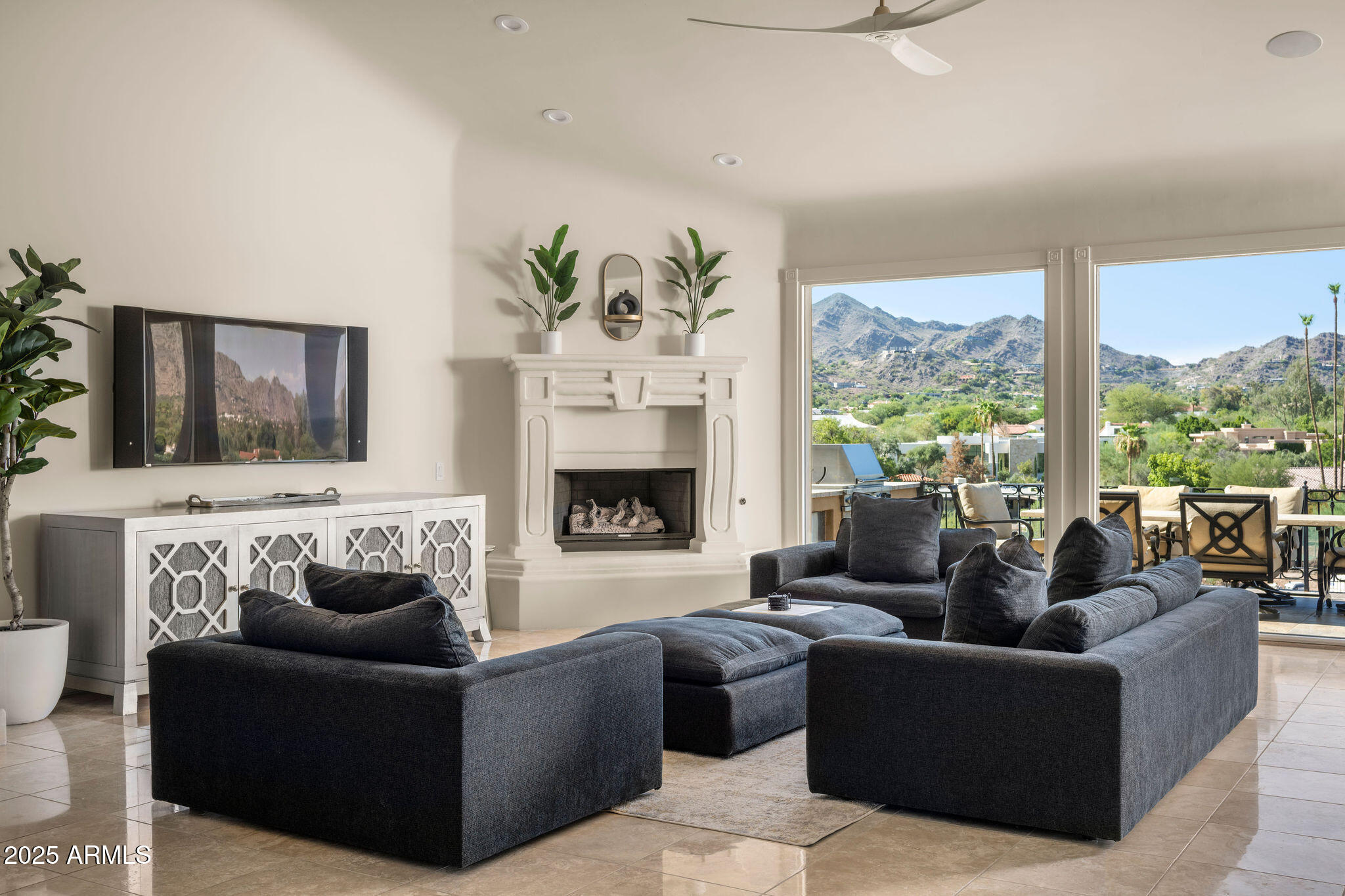4490 East Valley Vista Lane Paradise Valley, AZ 85253 - Photo 22 of 45 a living room with furniture and a fireplace