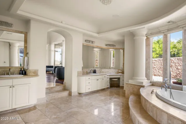 a spacious bathroom with a tub and sink