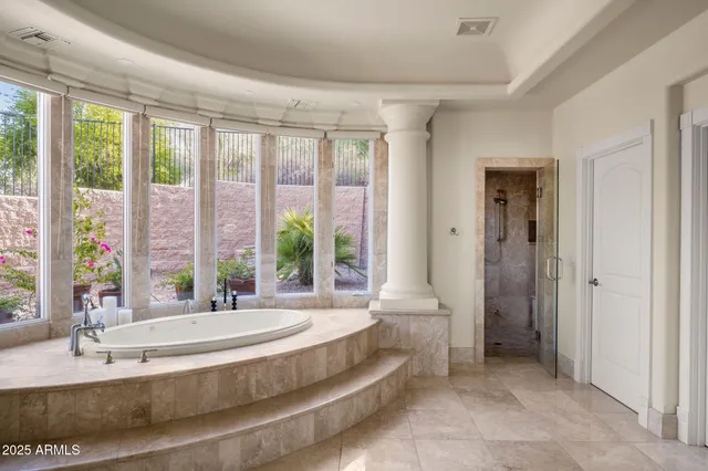 a living room with furniture and a painting on the wall