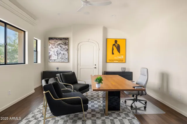 a large white couch sitting in a living room next to a window