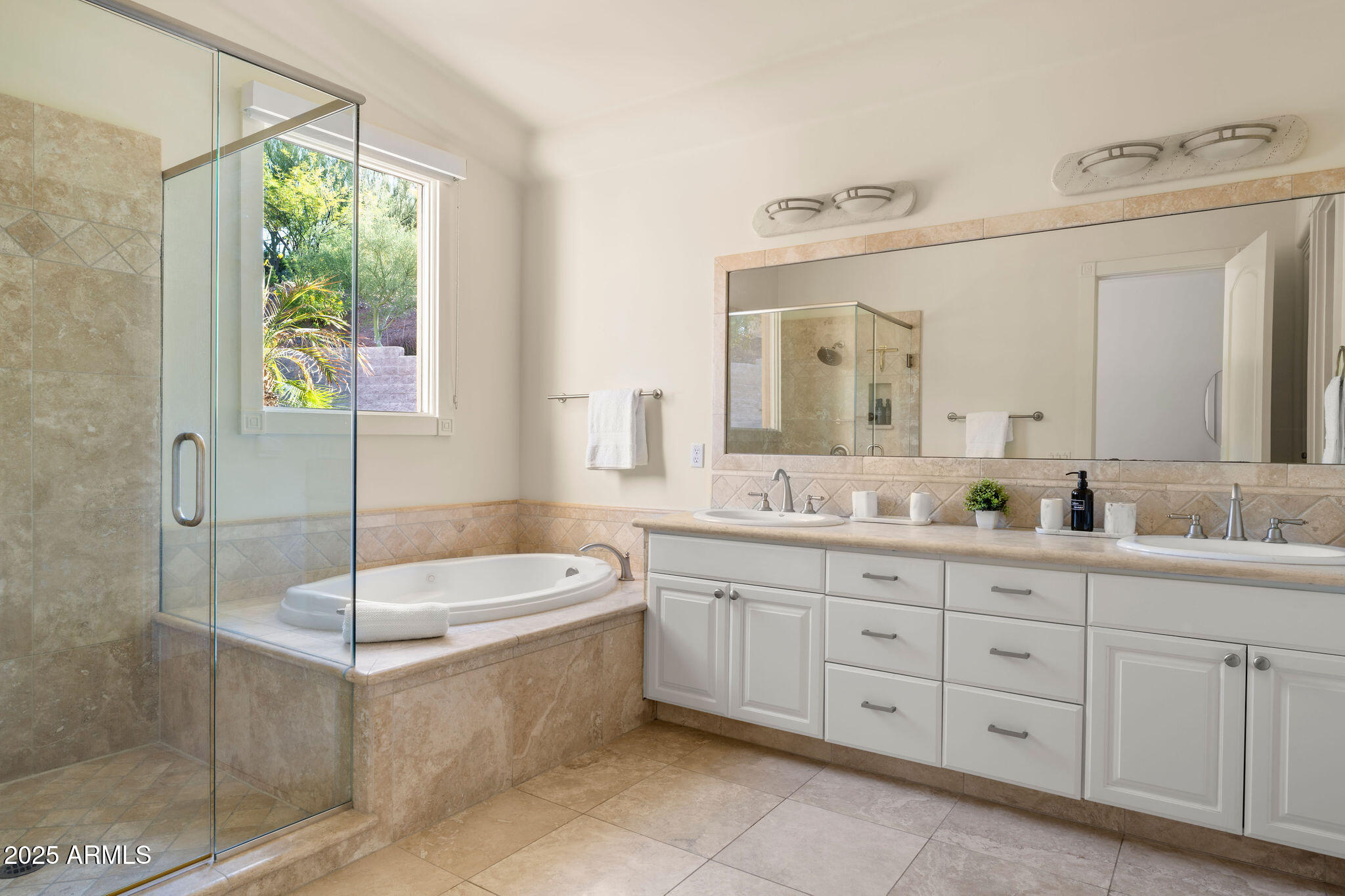 4490 East Valley Vista Lane Paradise Valley, AZ 85253 - Photo 30 of 45 a bathroom with a tub a sink and mirror