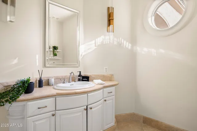 a kitchen with stainless steel appliances granite countertop white cabinets a sink and a window