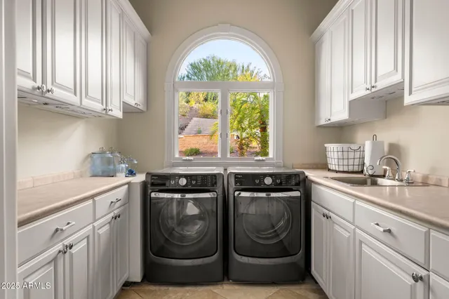 a bathroom with a granite countertop sink mirror vanity and toilet