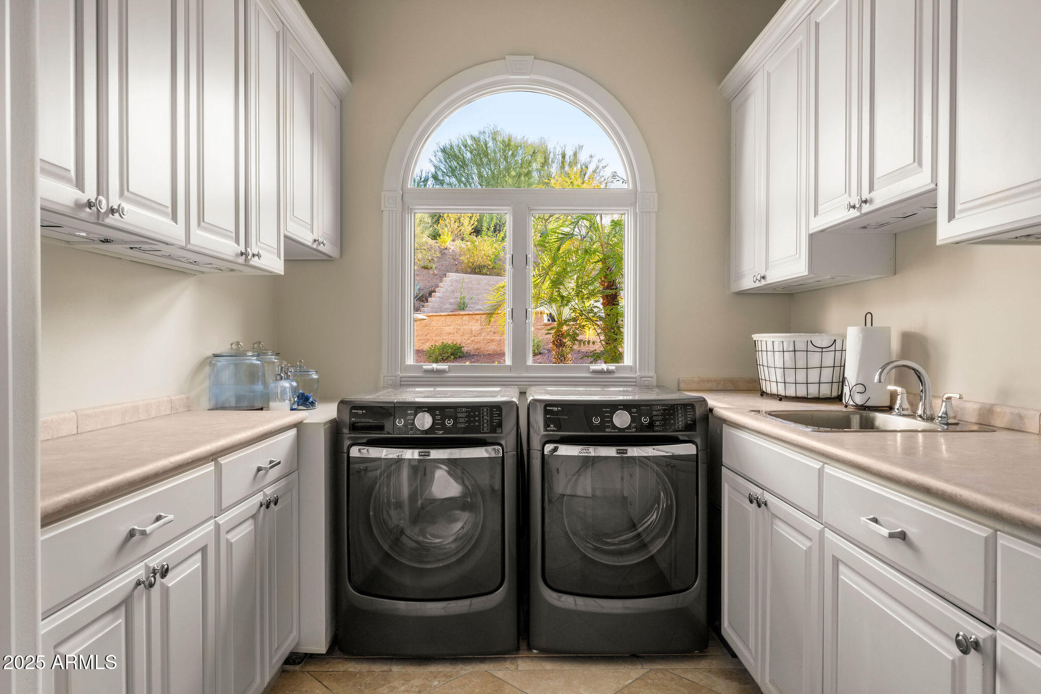4490 East Valley Vista Lane Paradise Valley, AZ 85253 - Photo 34 of 45 a kitchen with stainless steel appliances granite countertop white cabinets a sink and a window