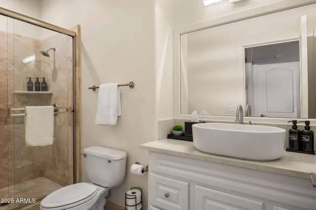 a kitchen with a sink and chairs