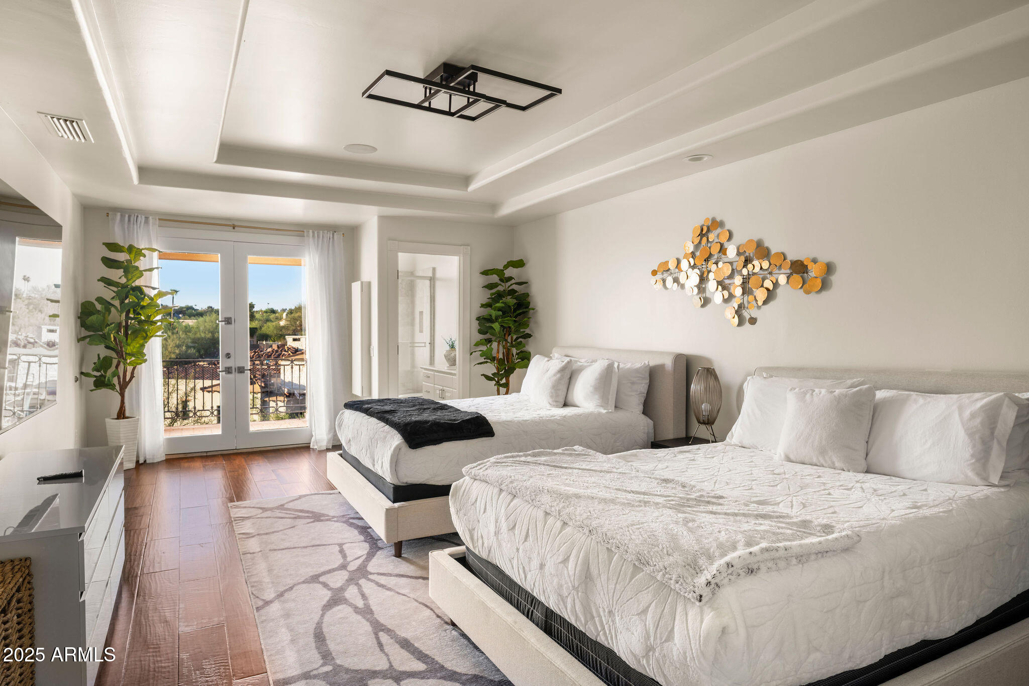 4490 East Valley Vista Lane Paradise Valley, AZ 85253 - Photo 41 of 45 a bedroom with a large bed and a couch