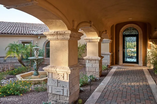 a front view of a house with outdoor seating
