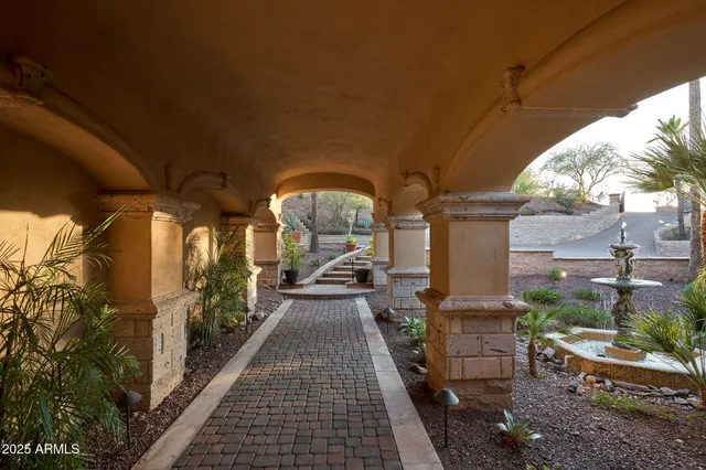 a view of a porch with chairs and potted plants