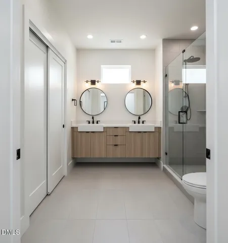 a spacious bedroom with a bed and wooden floor