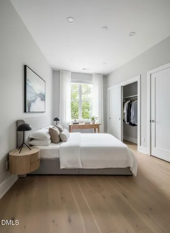 a bedroom with a bed and a window