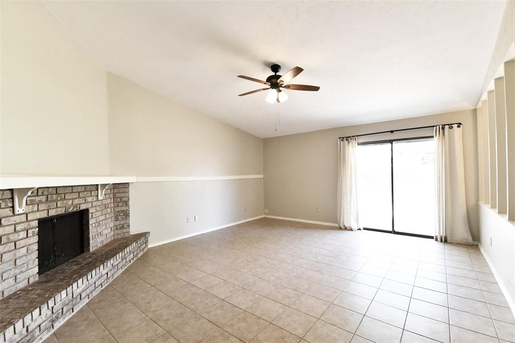 4113 Juneberry Street Fort Worth, TX 76137 - Photo 12 of 36 a view of empty room with fireplace and fan