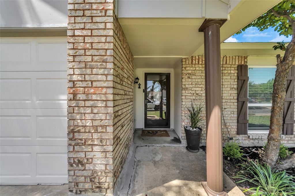 4113 Juneberry Street Fort Worth, TX 76137 - Photo 2 of 36 a view of entryway door with potted plants in front of door