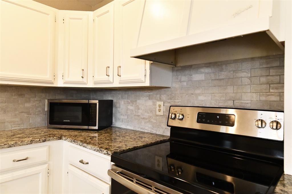 4113 Juneberry Street Fort Worth, TX 76137 - Photo 21 of 36 a kitchen with granite countertop a stove and a sink