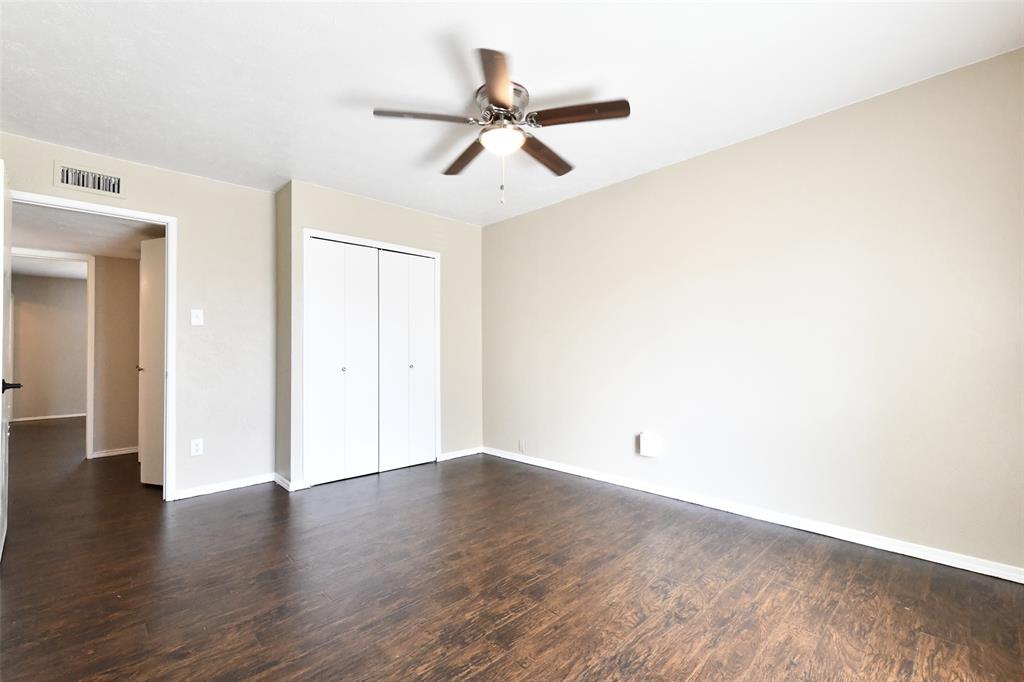 4113 Juneberry Street Fort Worth, TX 76137 - Photo 30 of 36 a view of a room with wooden floor and ceiling fan