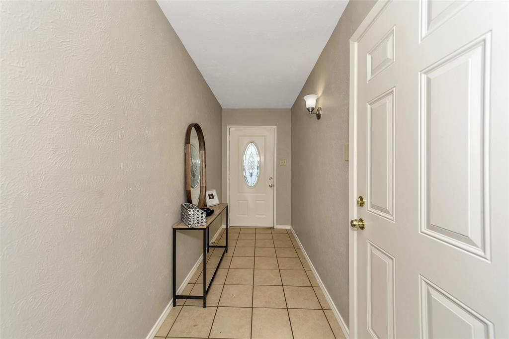 4113 Juneberry Street Fort Worth, TX 76137 - Photo 3 of 36 a view of a hallway with wooden floor and staircase