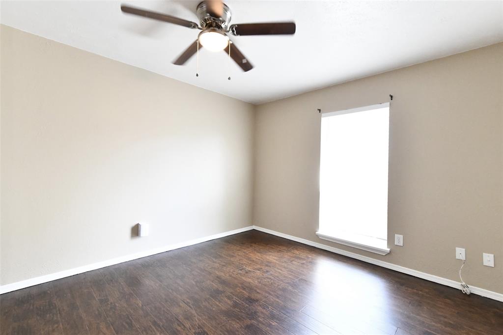 4113 Juneberry Street Fort Worth, TX 76137 - Photo 31 of 36 an empty room with wooden floor and windows