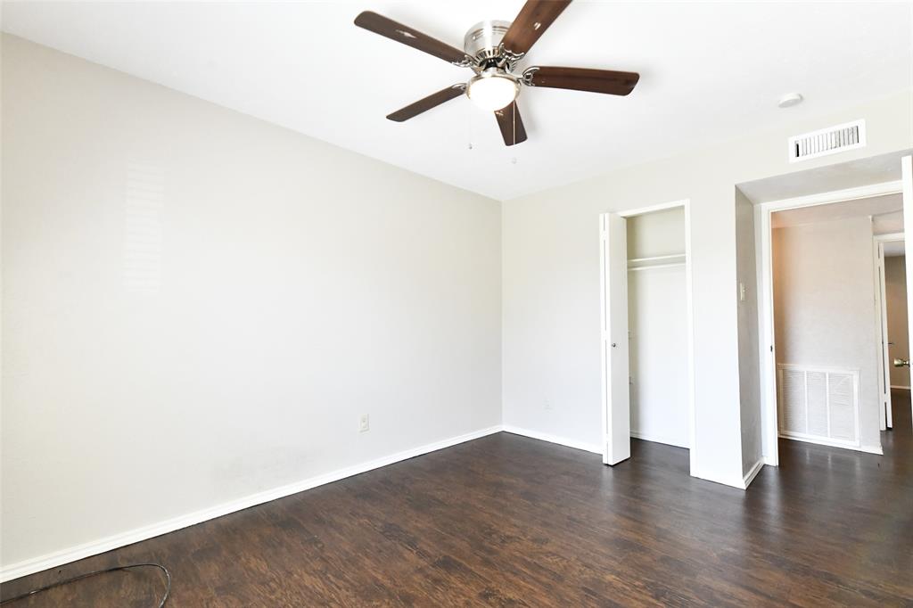 4113 Juneberry Street Fort Worth, TX 76137 - Photo 33 of 36 an empty room with wooden floor ceiling fan and window