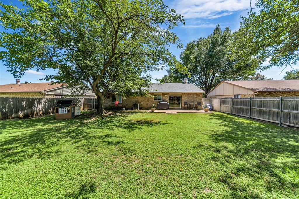 4113 Juneberry Street Fort Worth, TX 76137 - Photo 7 of 36 a front view of a house with garden