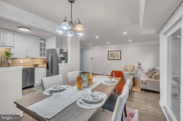 a living room with dining room and kitchen view