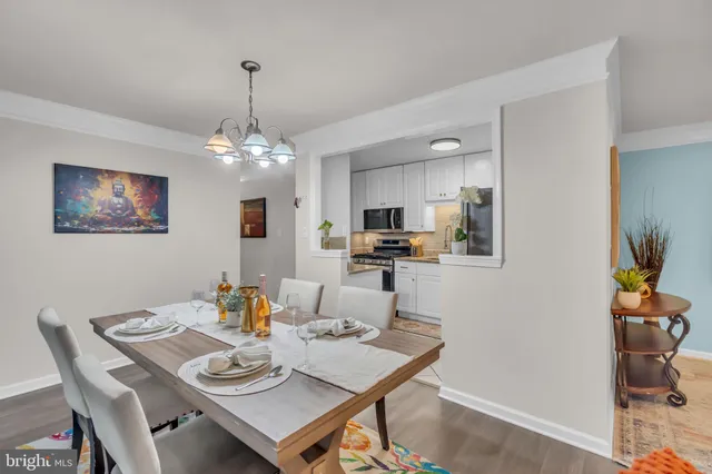 a view of a dining room with furniture and chandelier