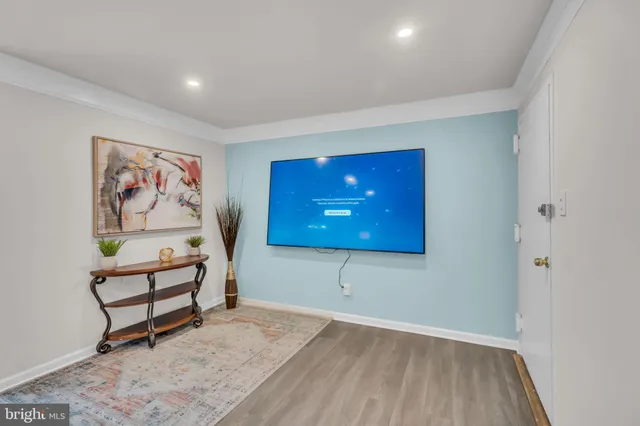 a view of a room with wooden floor and bench