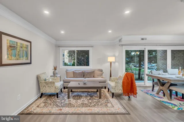 a living room with furniture and a table with wooden floor