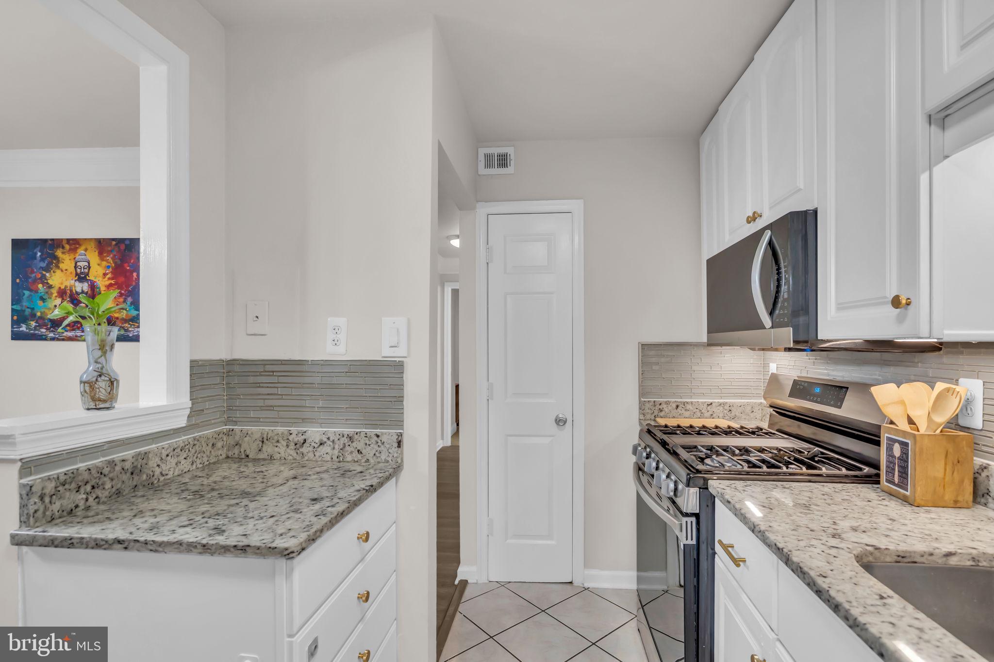2910 Kings Chapel Road, Unit 5 Falls Church, VA 22042 - Photo 9 of 25 a kitchen with granite countertop a sink stove and refrigerator