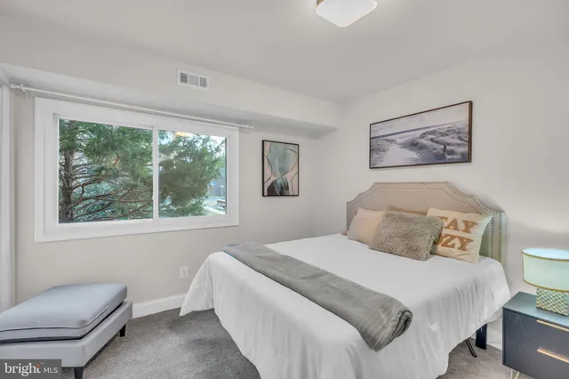 a bedroom with a bed and a couch