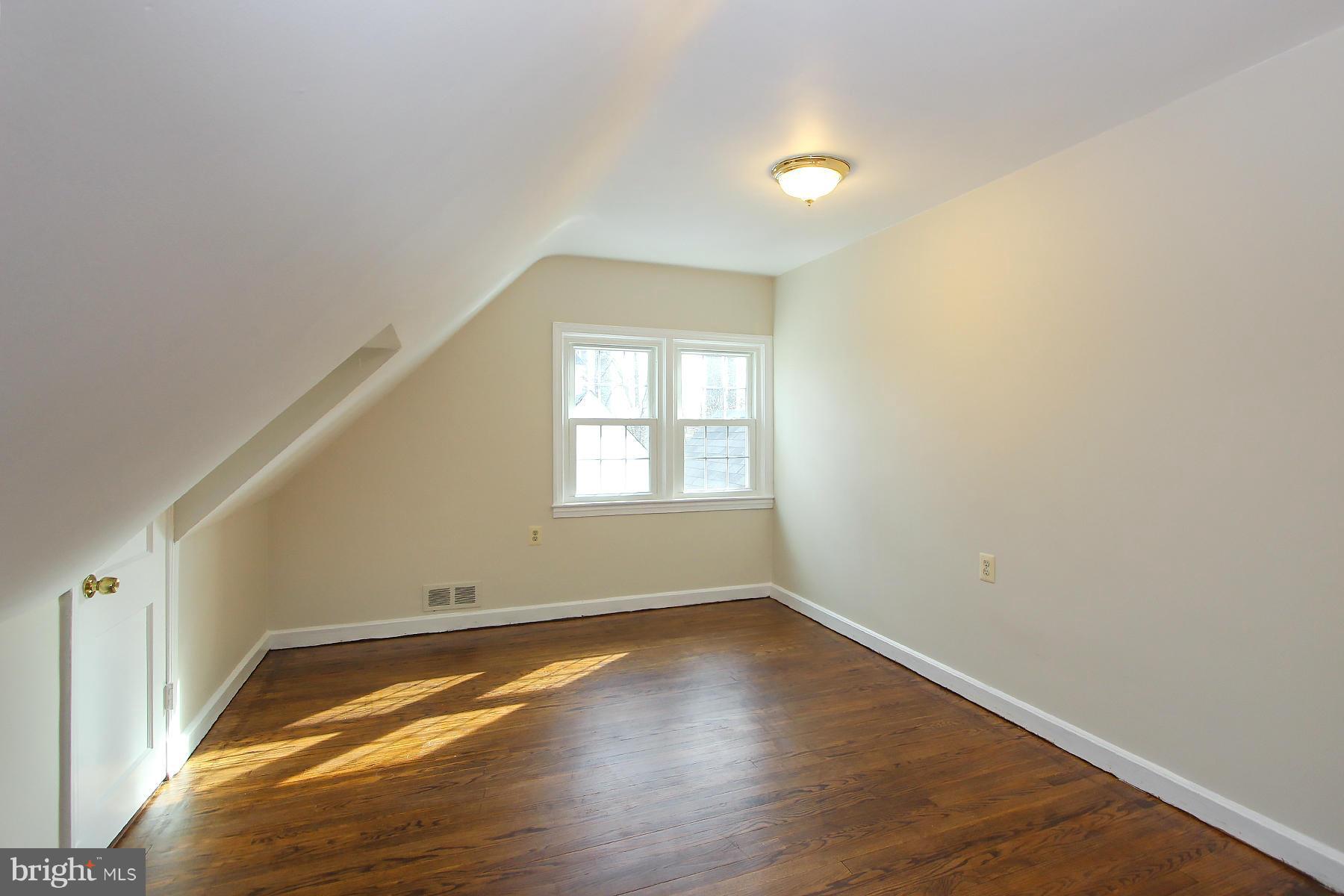 1111 Notley Road Silver Spring, MD 20904 - Photo 19 of 30 an empty room with wooden floor and windows