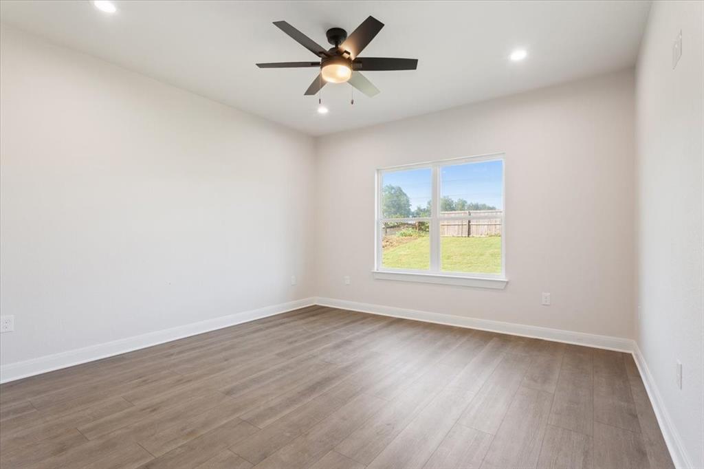 112 Great Trail Road Riesel, TX 76682 - Photo 13 of 28 an empty room with a window and a ceiling fan