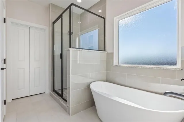 a bathroom with a bathtub and a shower