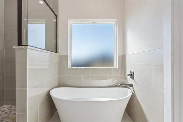 a white bath tub sitting in a bathroom