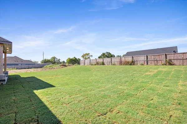 a view of a garden with a building in the background