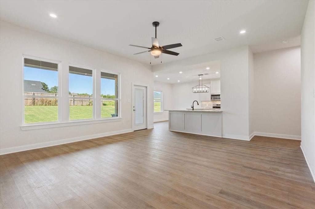 112 Great Trail Road Riesel, TX 76682 - Photo 7 of 28 a view of an empty room with window and wooden floor