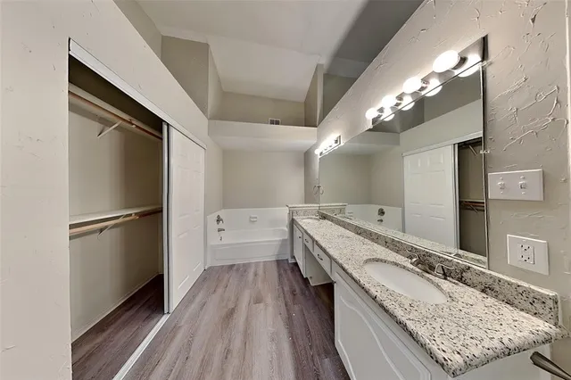 an empty room with ceiling fan and window