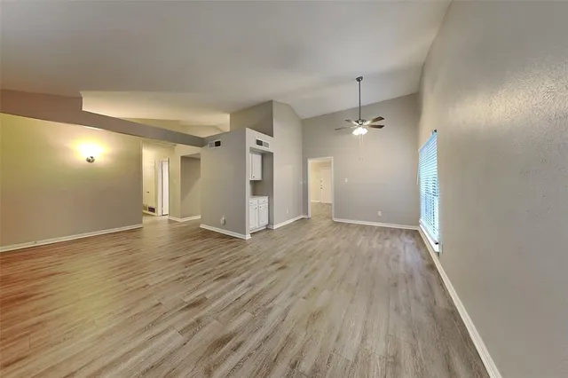 a kitchen with kitchen island granite countertop a stove top oven a sink a counter space and cabinets
