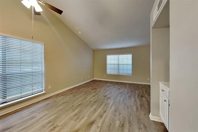wooden floor in an empty room with a window