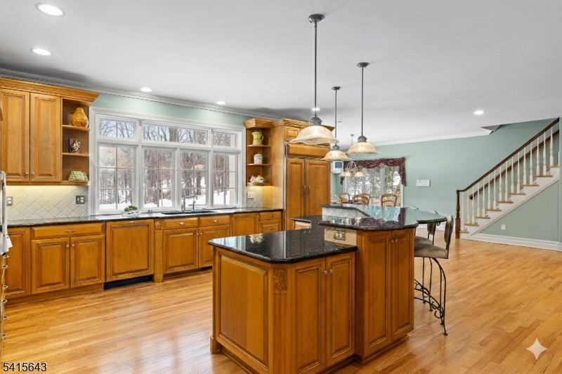 7 Timber Ridge Road Far Hills, NJ 07931 - Photo 9 of 48 a kitchen with stainless steel appliances granite countertop sink stove and wooden floor