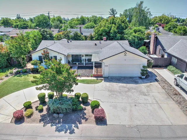 a house with lots of trees in the background