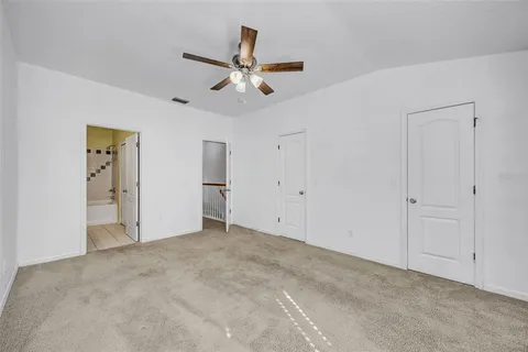 an empty room with closet and windows