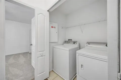 a view of storage and utility room with washer and dryer