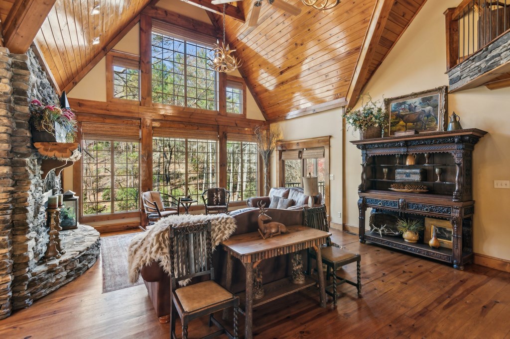 124 River Shoals Road Ellijay, GA 30536 - Photo 11 of 57 a living room with fireplace furniture and a floor to ceiling window