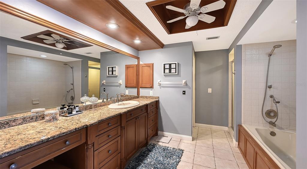 3850 Mariners Walk, Unit 714 Cortez, FL 34215 - Photo 17 of 59 a spacious bathroom with a sink a mirror and a shower