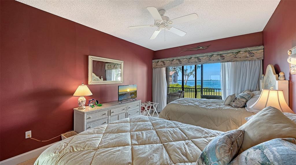 3850 Mariners Walk, Unit 714 Cortez, FL 34215 - Photo 19 of 59 a bedroom with a large bed and a window
