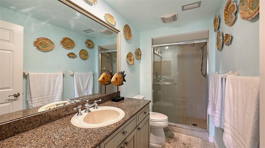 3850 Mariners Walk, Unit 714 Cortez, FL 34215 - Photo 20 of 59 a bathroom with a granite countertop toilet sink and shower