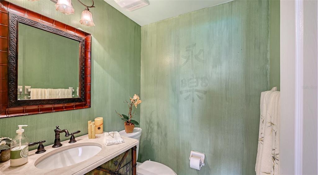 3850 Mariners Walk, Unit 714 Cortez, FL 34215 - Photo 22 of 59 a bathroom with a sink a toilet and mirror